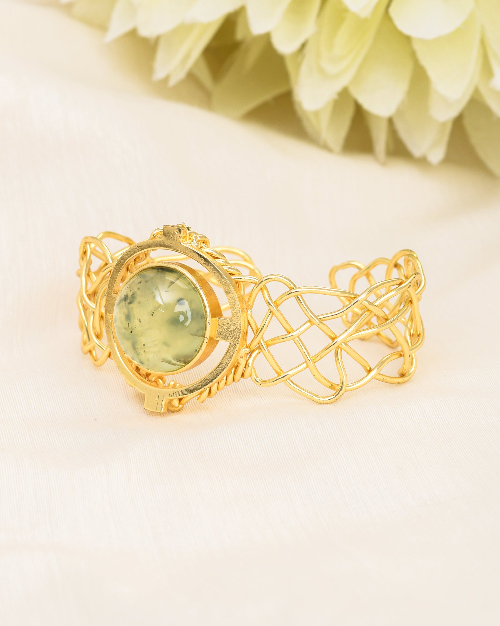 Designer cuff bracelet in antique gold with a natural prehnite gemstone – bold and stylish accessory
