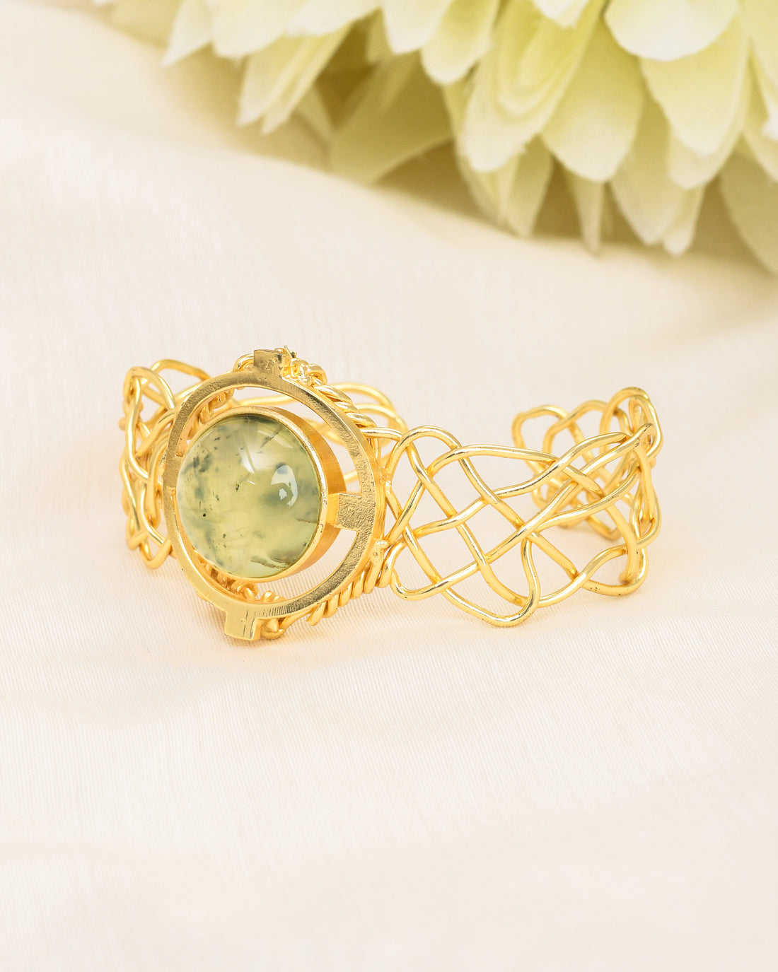 Designer cuff bracelet in antique gold with a natural prehnite gemstone – bold and stylish accessory
