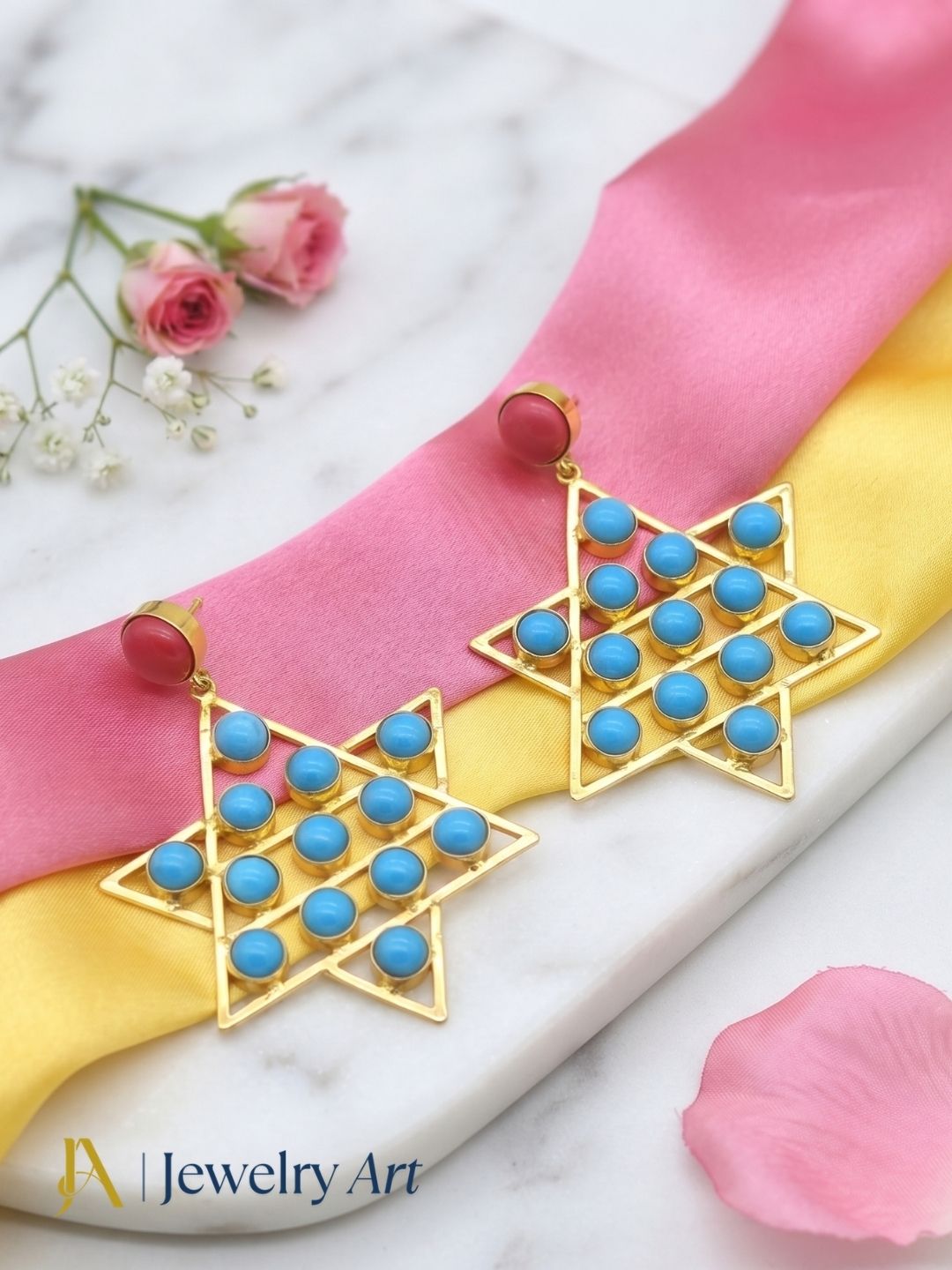 Decorative setup highlighting gold plated Red Blue Glass designer earrings
