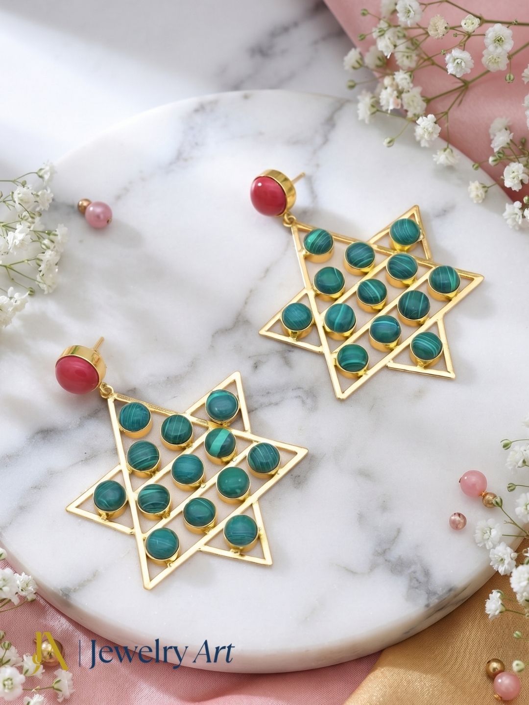 Amazing gold plated Red Glass and Malachite astronomical star designer party wear dangle drop earrings showcased in luxury decorative jewelry styling.
