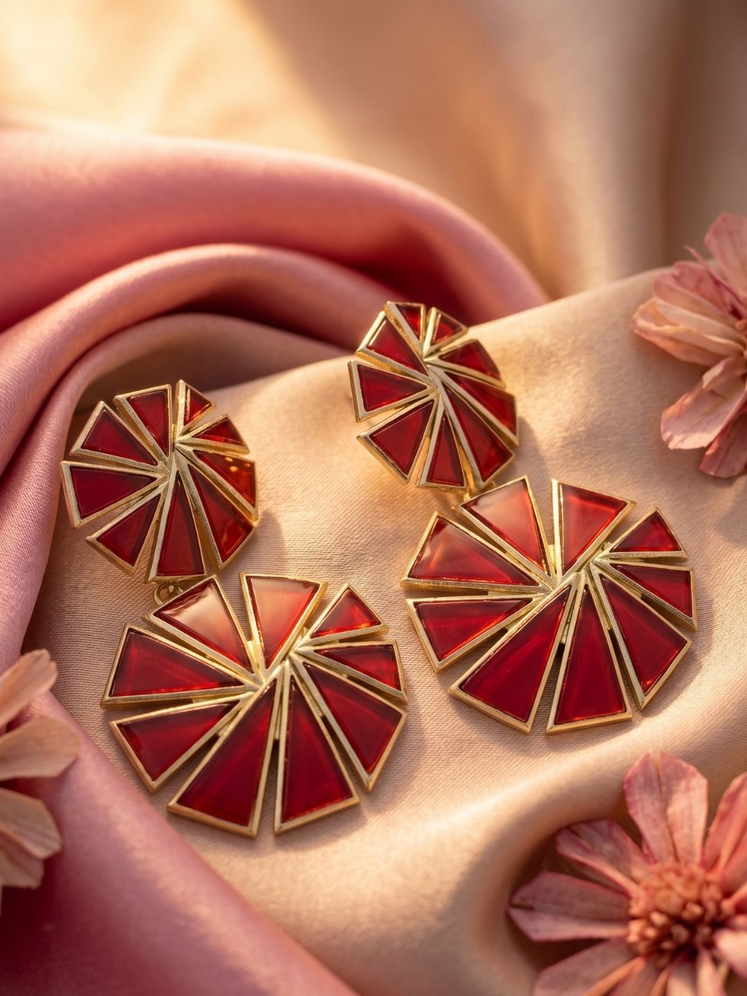 Luxury jewelry photography featuring gold plated red glass geometric earrings
