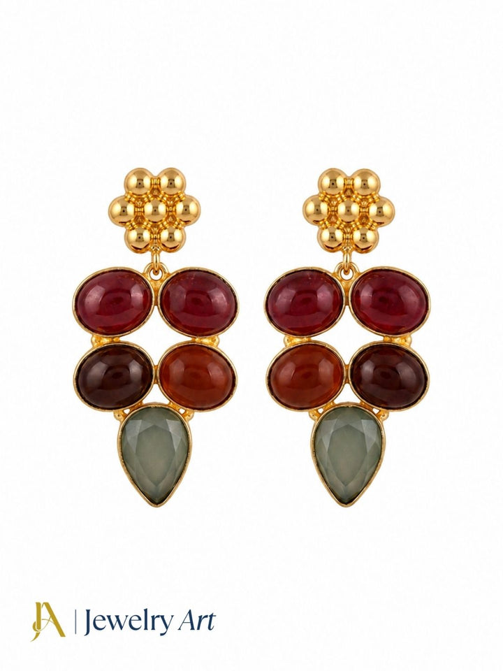Designer red onyx aquamarine gemstone earrings on a pure white background
