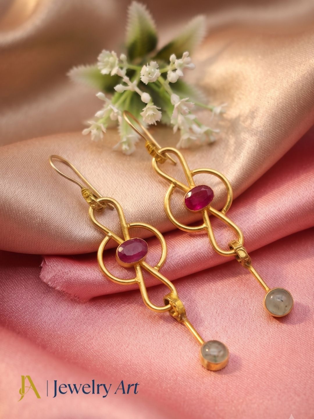 Decorative setup highlighting gold plated Prehnite Red Hathipara gemstone earrings
