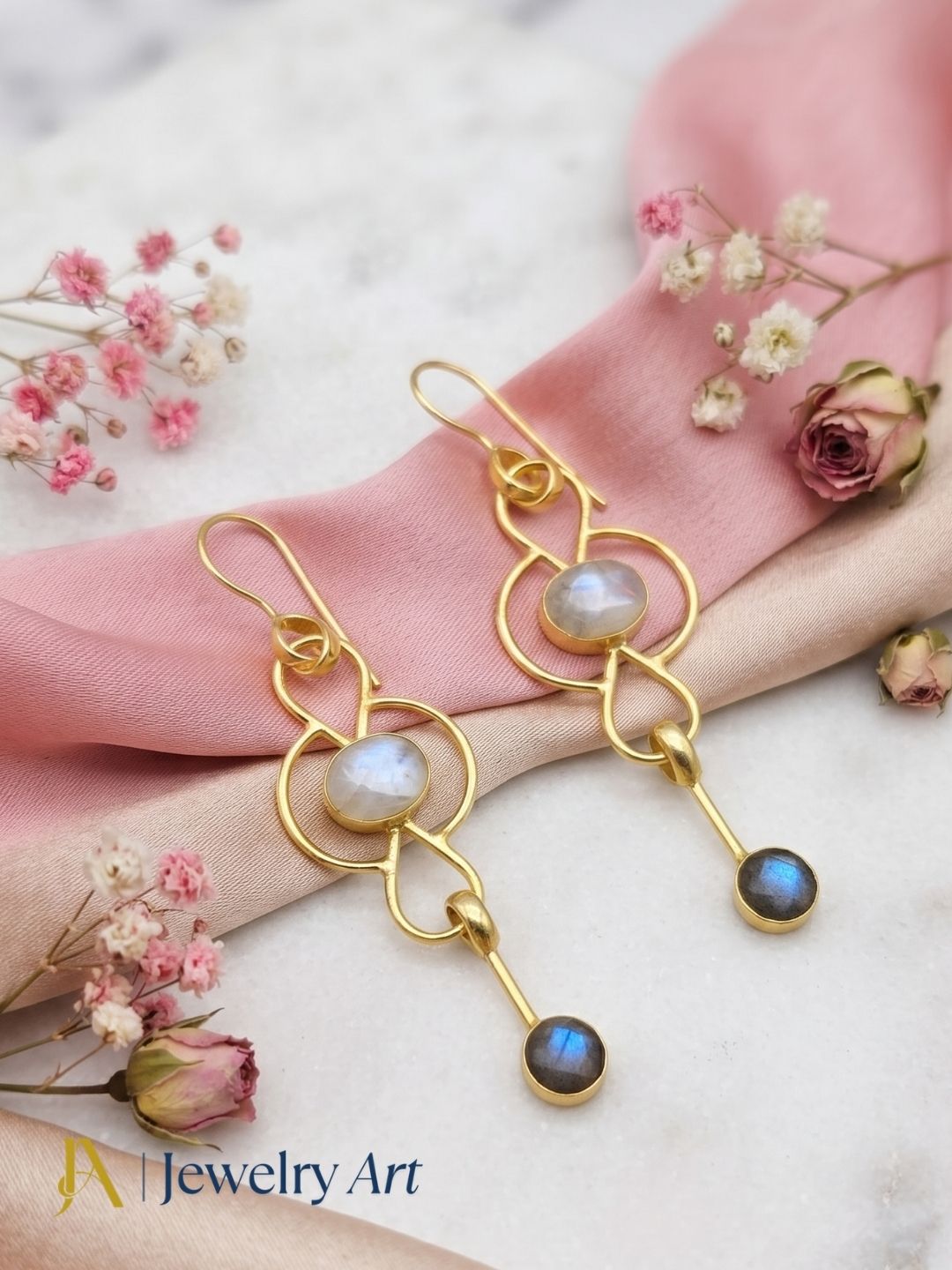 Luxury jewelry photography featuring gold plated White Rainbow Labradorite earrings
