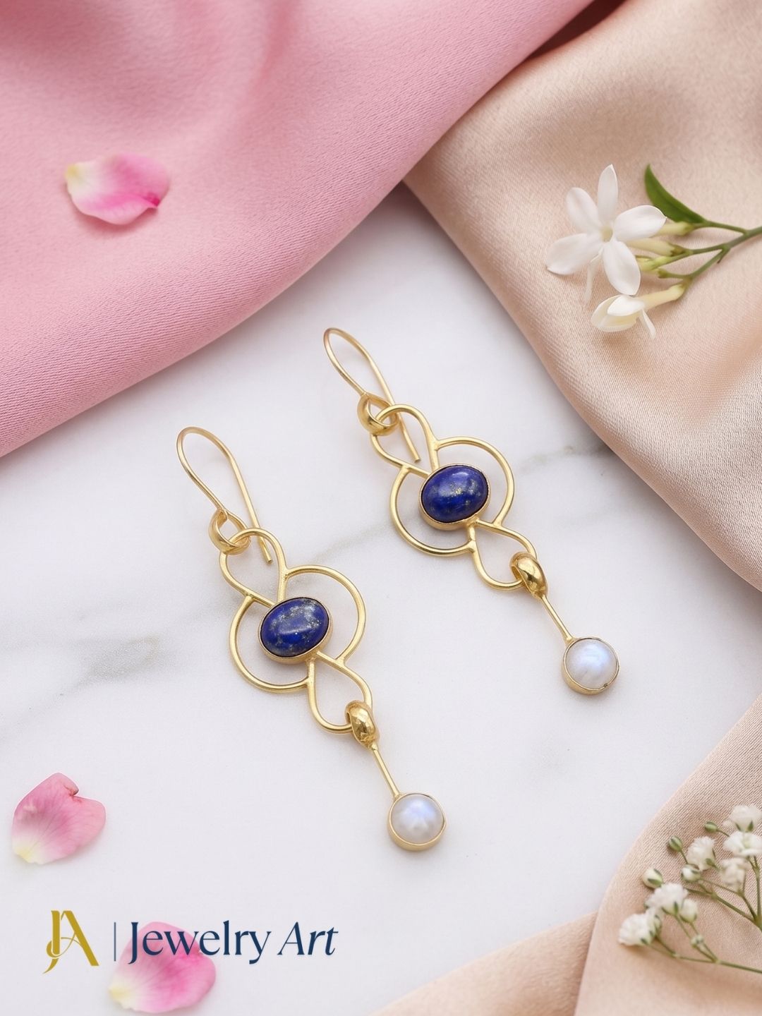 Artistic flat lay of gold plated Lapis White Rainbow gemstone earrings
