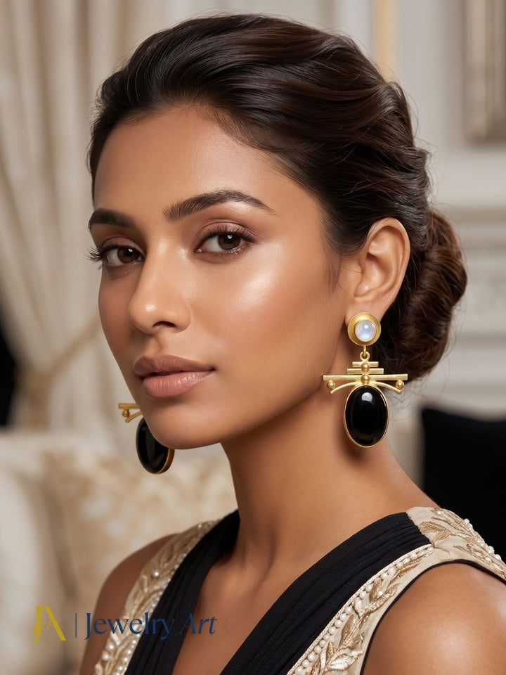 Woman wearing gold plated black onyx and white rainbow dangle earrings
