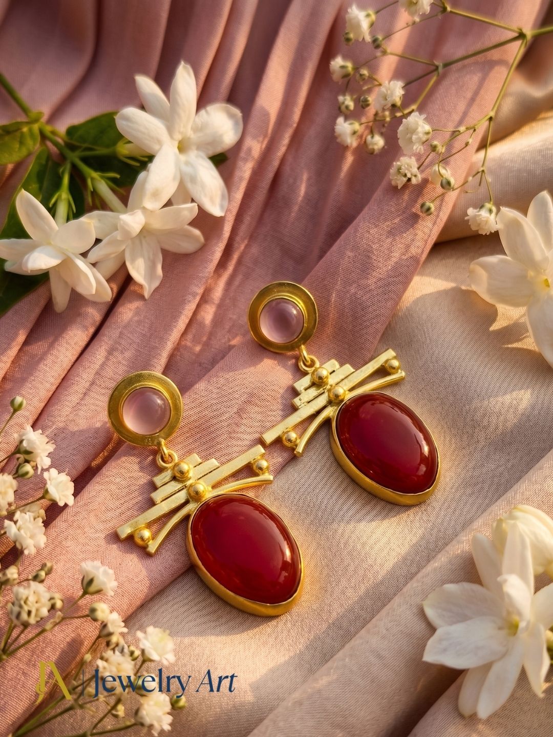 Woman styling gold plated rose quartz red onyx earrings with contemporary fashion

