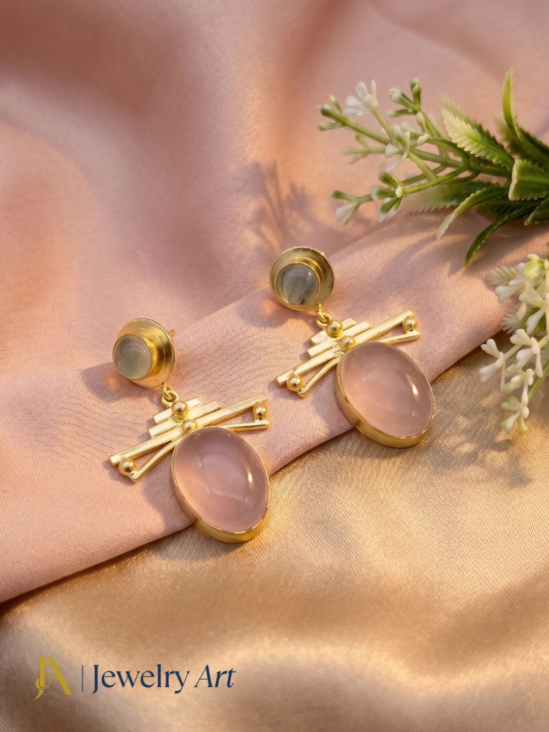 Artistic display of handcrafted rose quartz prehnite dangle earrings
