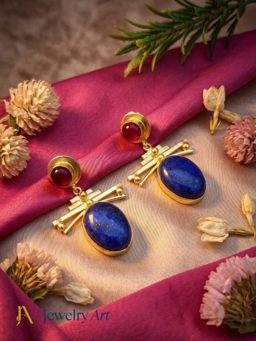 Gold plated lapis and red onyx earrings showcased in luxury decorative jewelry styling.
