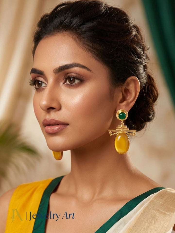 Woman wearing gold plated yellow chalcedony and green onyx dangle earrings
