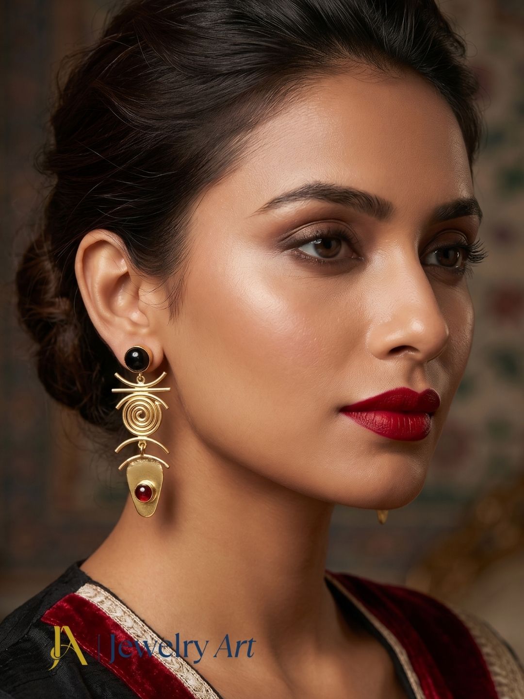 Woman wearing gold plated black and red onyx dangle earrings
