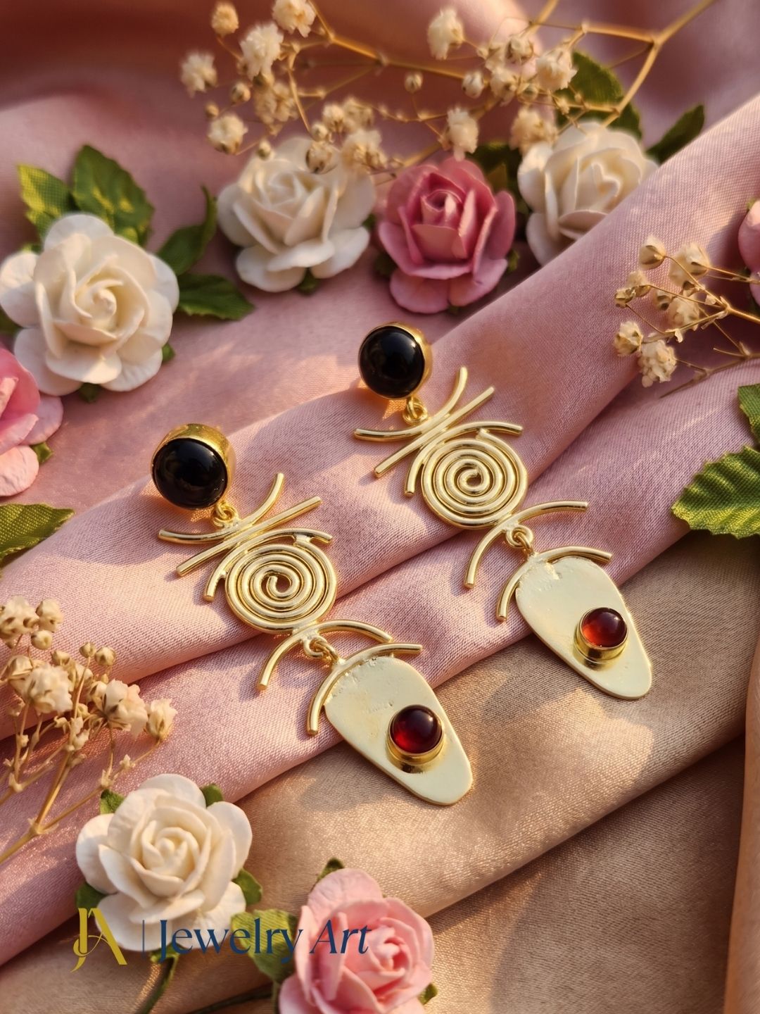 Elegant black and red onyx earrings arranged in a premium jewelry shoot
