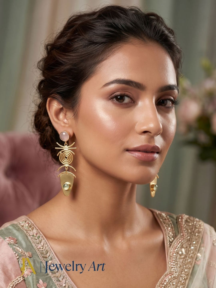 Woman wearing designer gold plated rose quartz and prehnite gemstone earrings.
