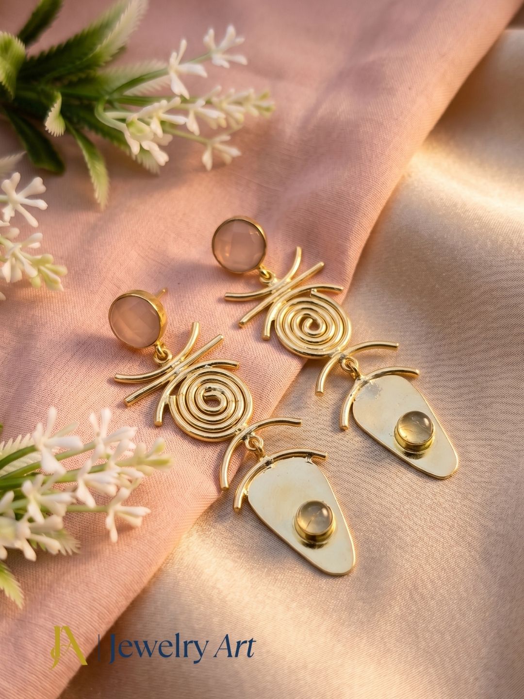 Gold plated rose quartz and prehnite earrings showcased in luxury decorative jewelry styling.
