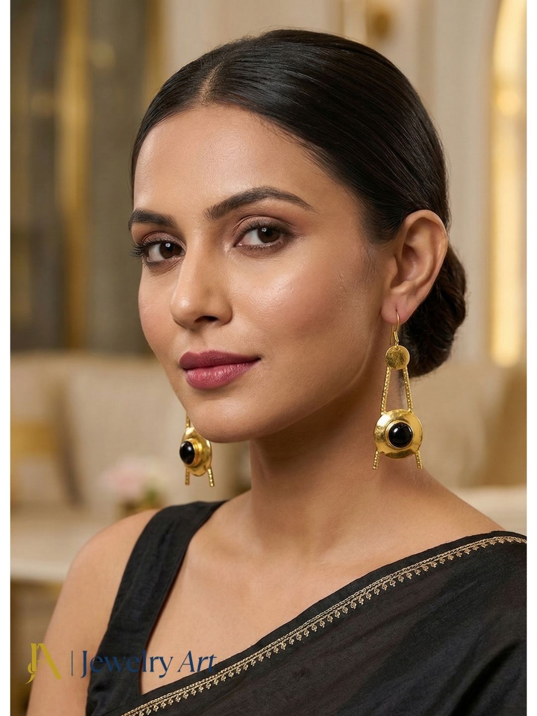 Designer gold tone earrings with black onyx and subtle shine 
