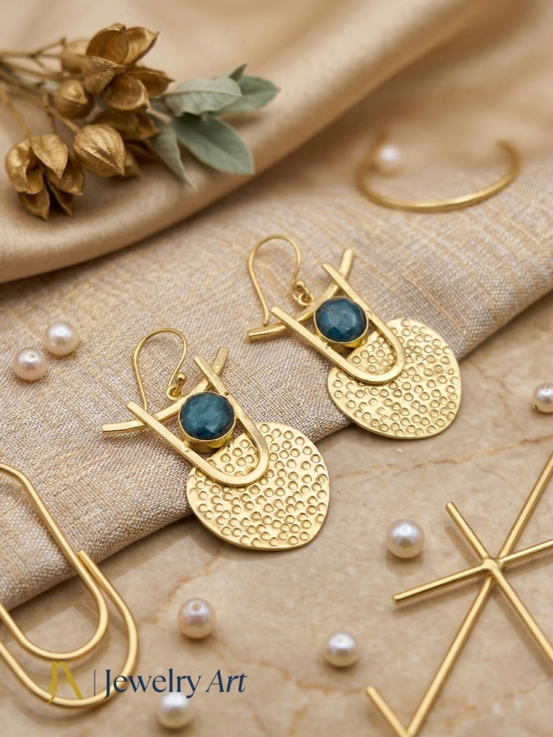 Modern gold tone earrings with green hathipara stone faceted design
