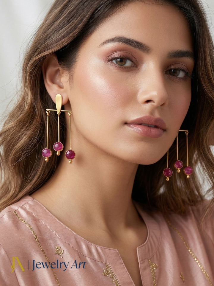 Unique gold plated earrings with red Hathipara stone strong color presence
