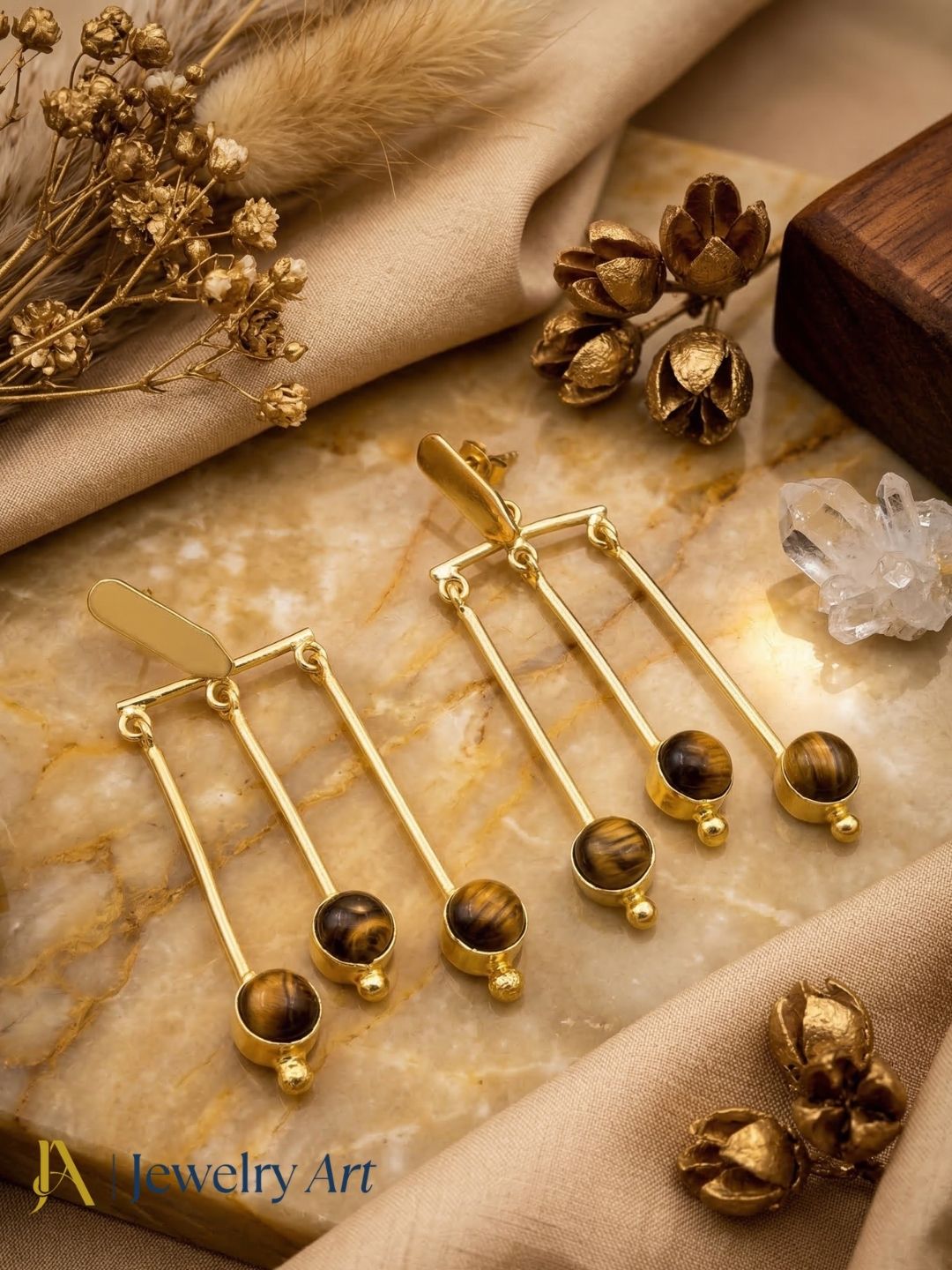 Modern gold finish dangling earrings with tiger eye stone statement look

