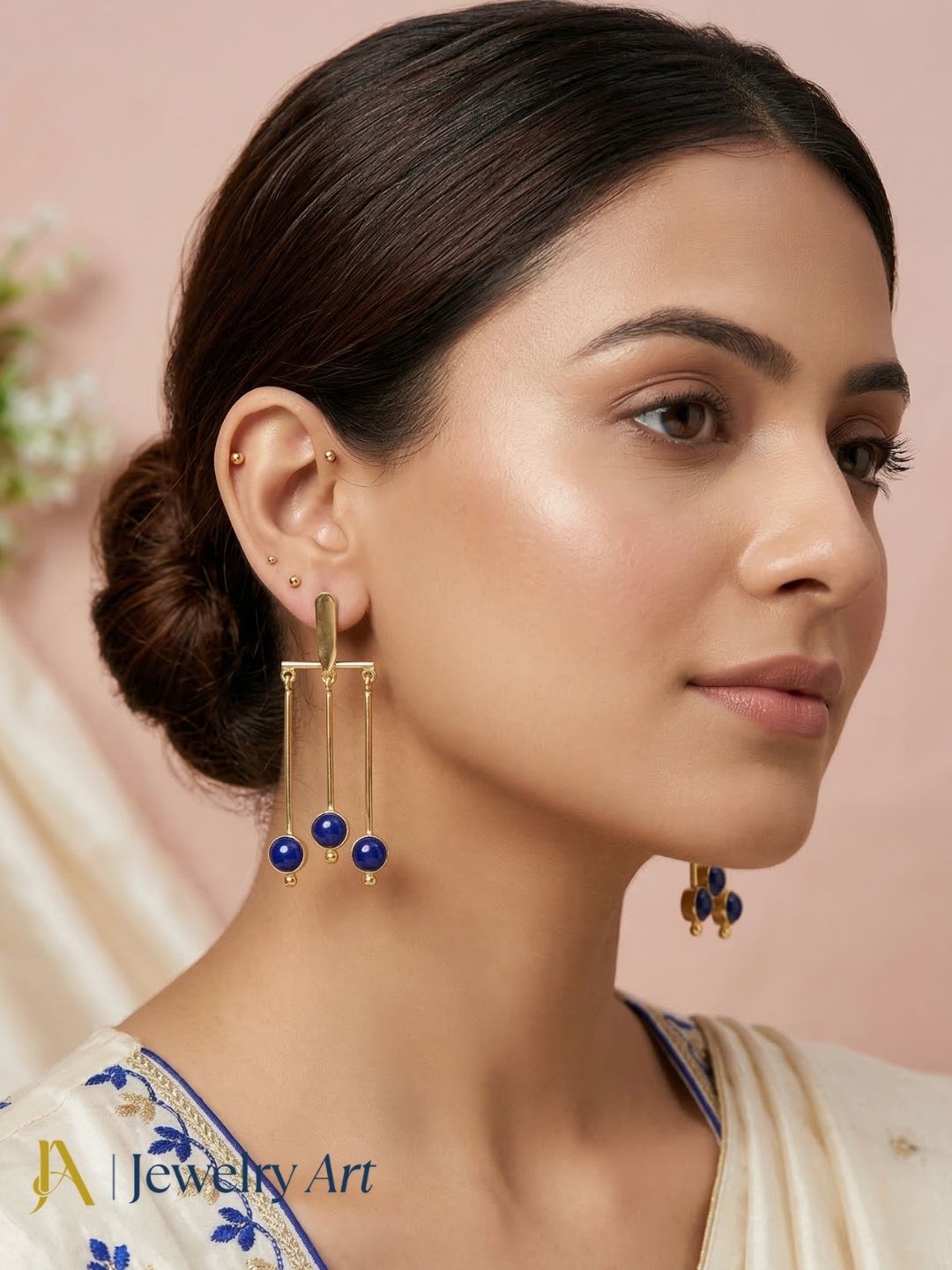 Luxury gold plated drop earrings with vibrant blue glass stone detail
