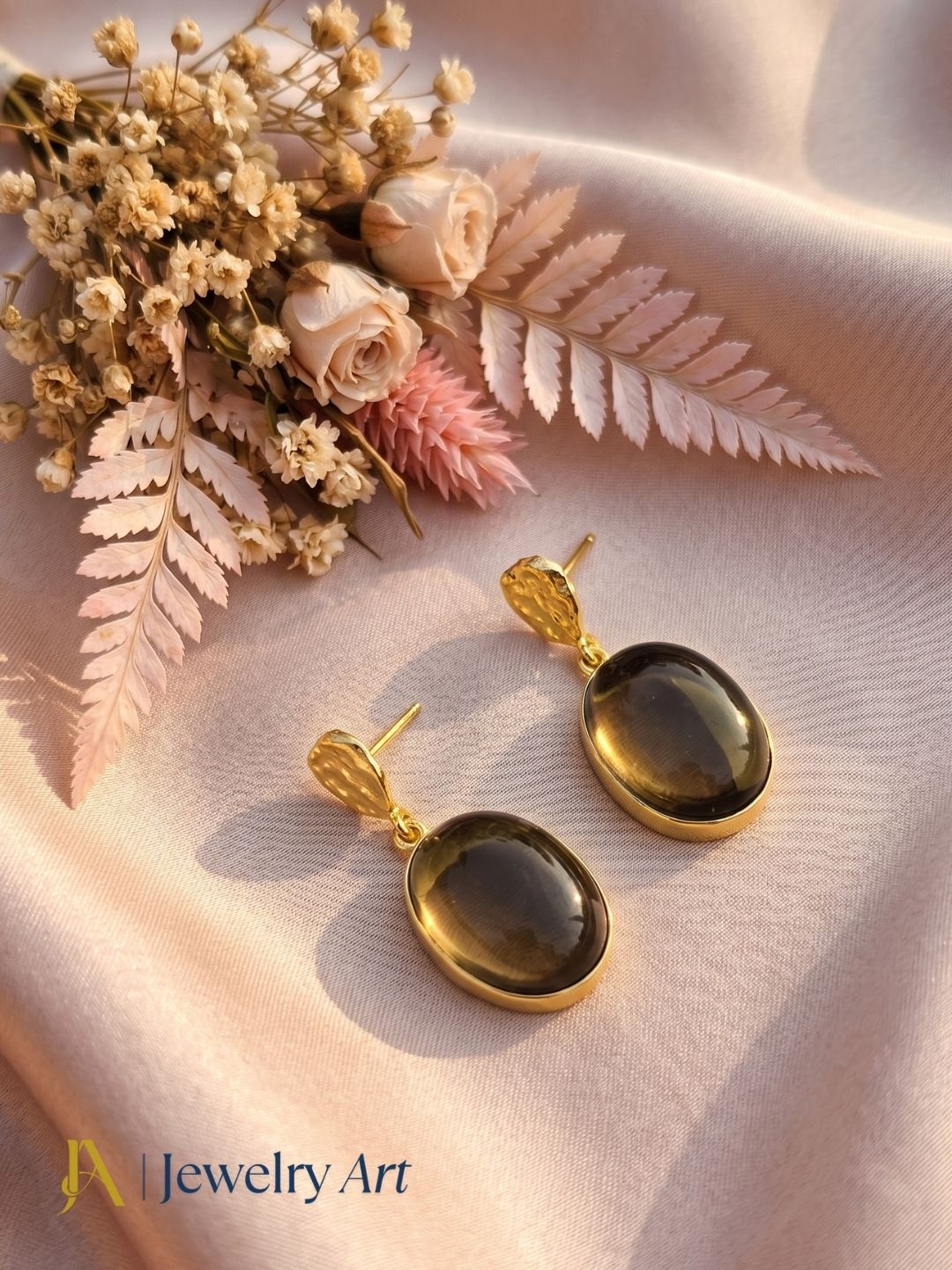 Premium smoky quartz dangle earrings featured in decorative product photography
