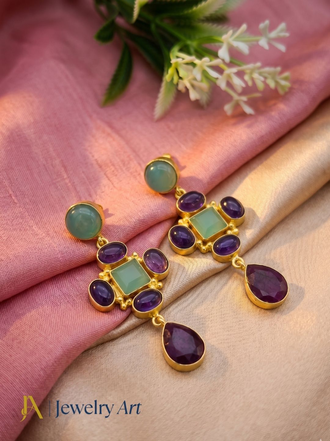 Decorative setup highlighting colorful gemstone earrings with gold plating
