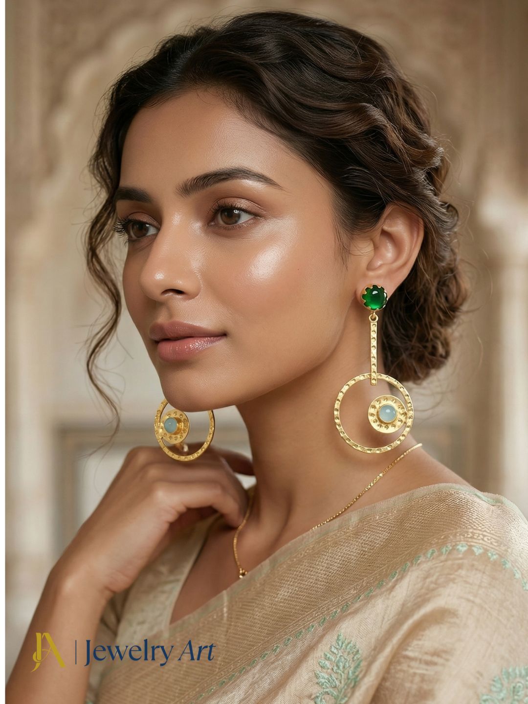 Handmade gold tone earrings featuring green glass and aquamarine blue stones
