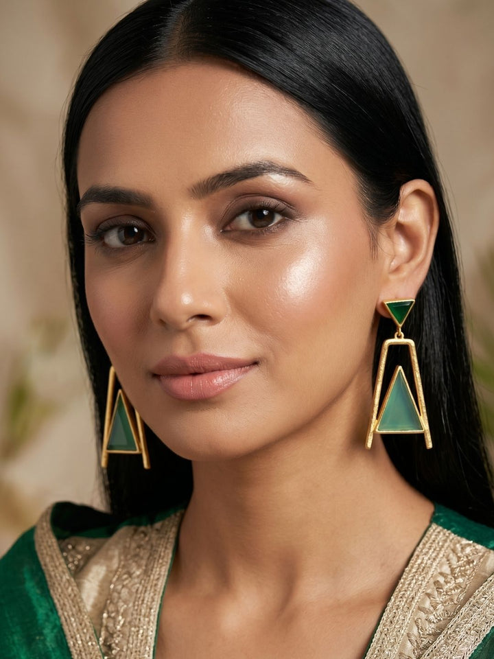 Woman wearing elegant gold plated green onyx green chalcedony geometric dangle earrings
