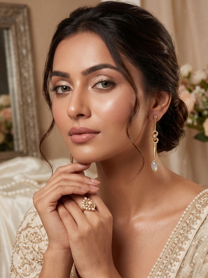 Close-up portrait featuring elegant white rainbow gemstone earrings with luxurious designer appeal.
