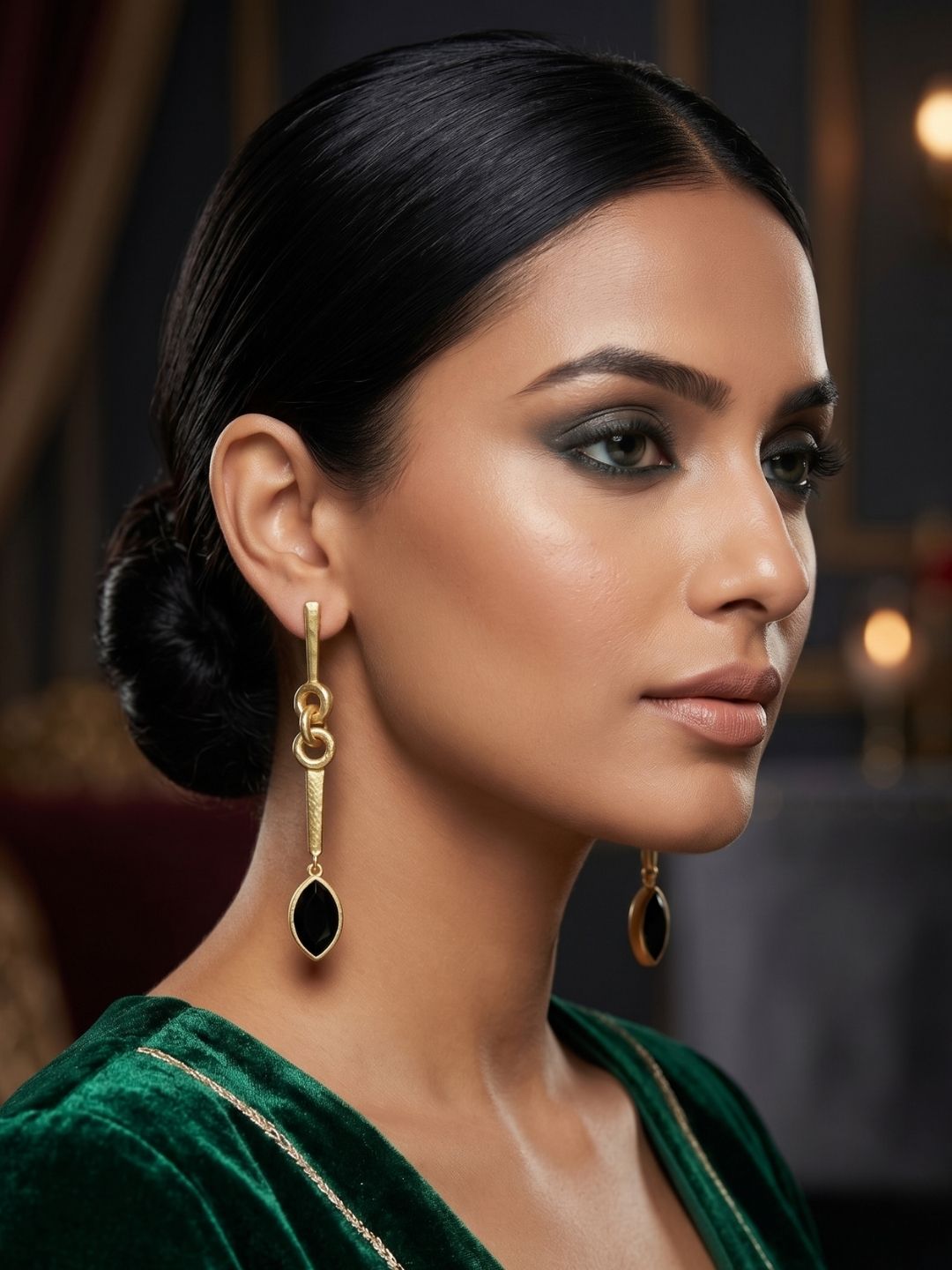 Female model wearing designer green onyx stone long dangle earrings, g handcrafted gold plated jewelry with natural gemstone accent
