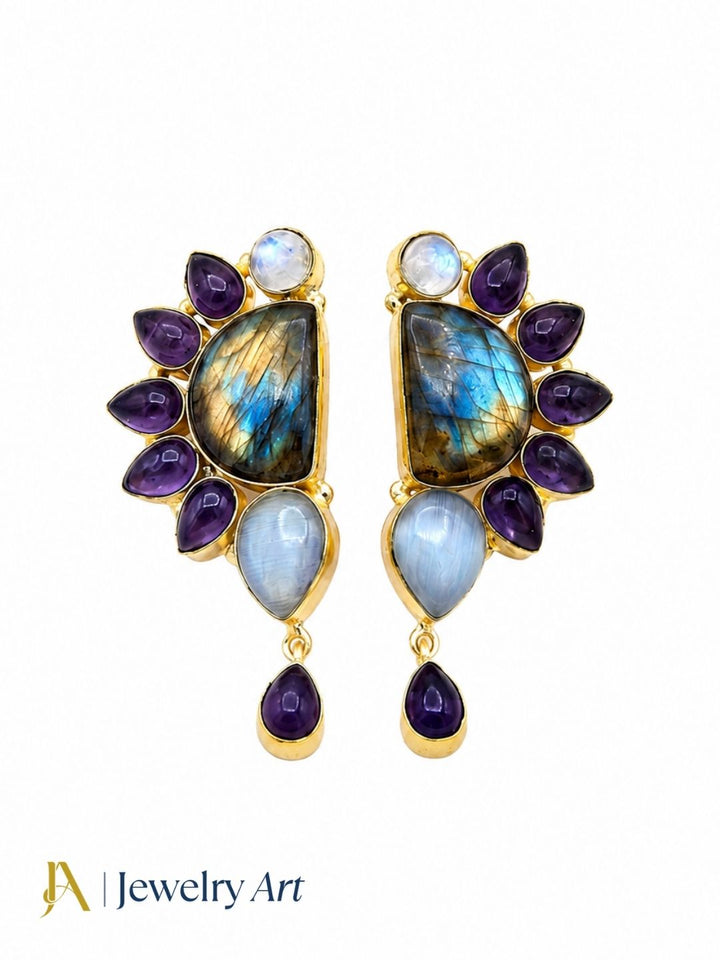 Close-up of iridescent labradorite, purple amethyst and monalisa gemstones in handcrafted drop earring
