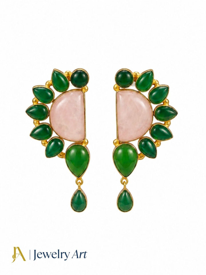 Close-up of natural rose quartz and green onyx gemstones in gold plated earring setting
