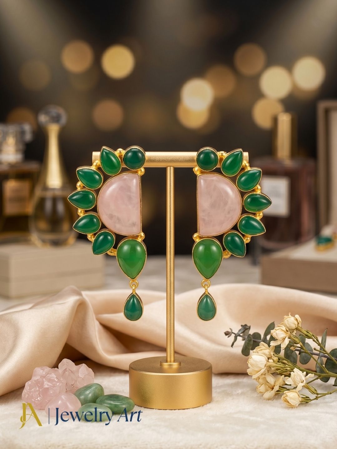 designer handcrafted rose quartz green onyx gold plated dangle drop earrings on display stand

