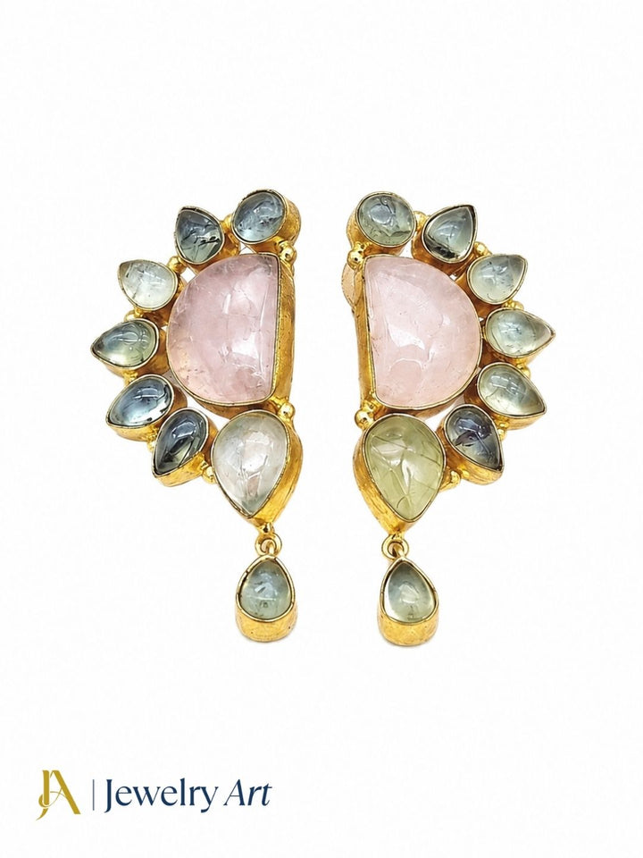 Handmade rose quartz prehnite gold plated dangle drop earrings flat lay with soft blush floral props — artisan gemstone jewelry styling
