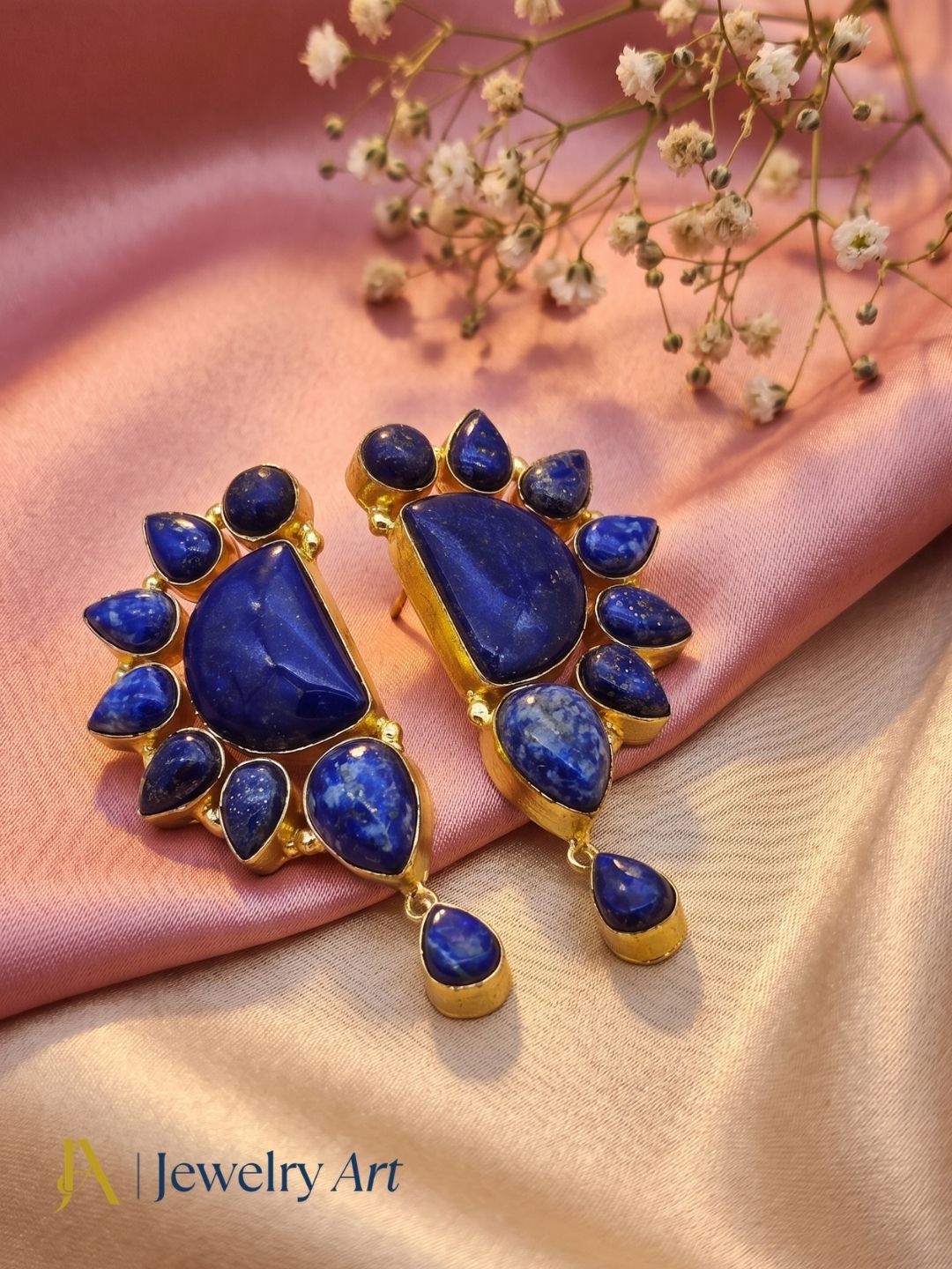 Woman wearing stylish gold plated lapis multi stone designer party earrings —  deep blue lapis lazuli detail
