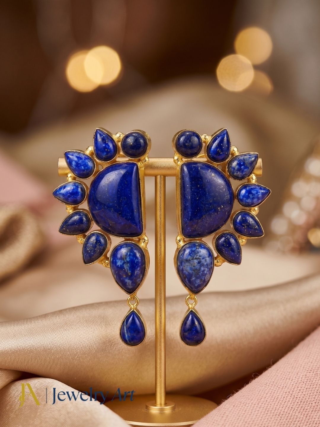 Pair of stylish gold plated lapis multi stone designer party earrings hanging on T-bar jewelry display stand
