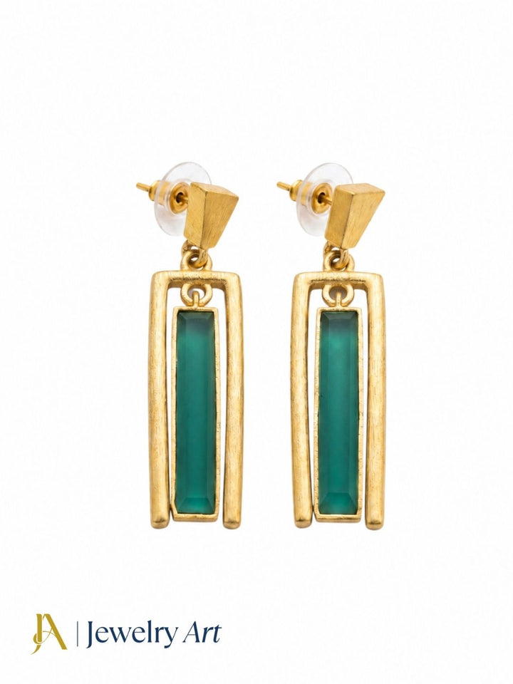 Side profile of model wearing gold plated aquamarine geometric designer dangle earrings showing clean architectural silhouette against neck
