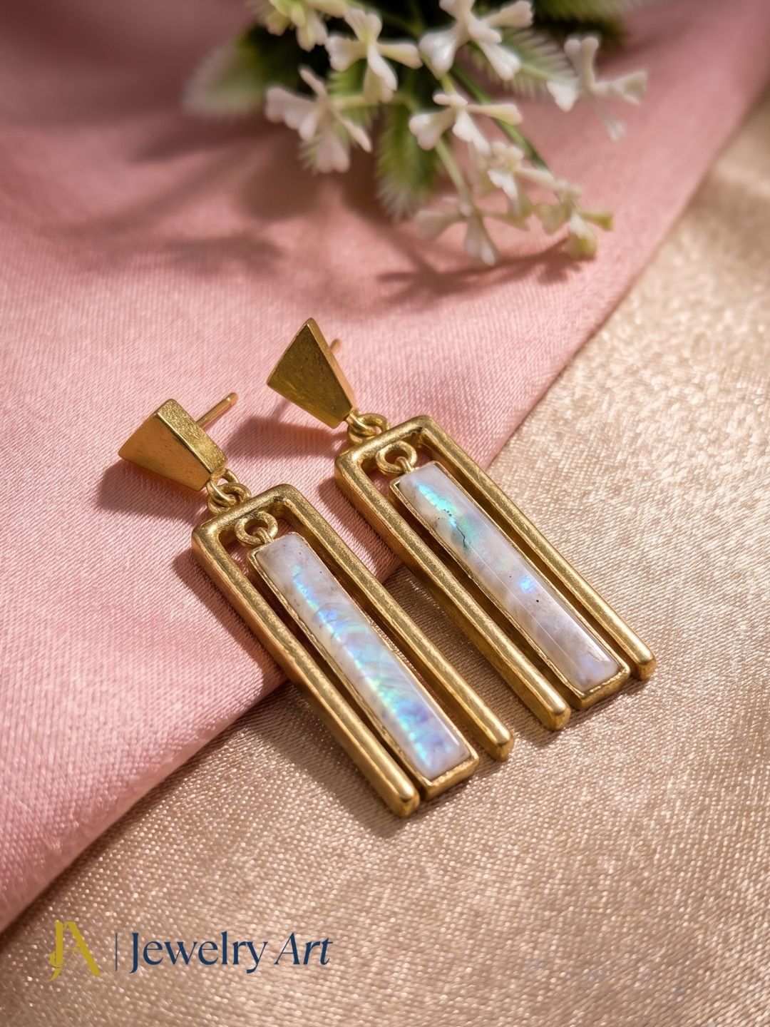 Designer gold plated drop earrings featuring white rainbow gemstones and modern geometric craftsmanship.
