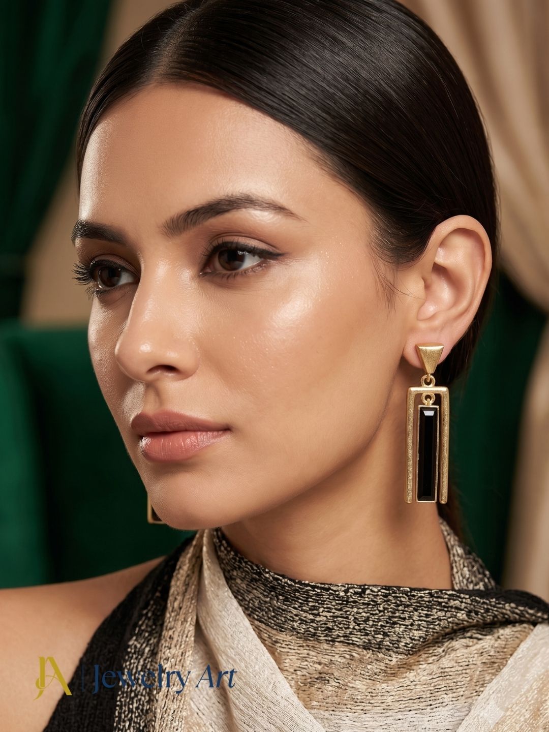 Fashion model wearing black onyx gemstone dangle earrings with gold plated finish for a sophisticated modern look.
