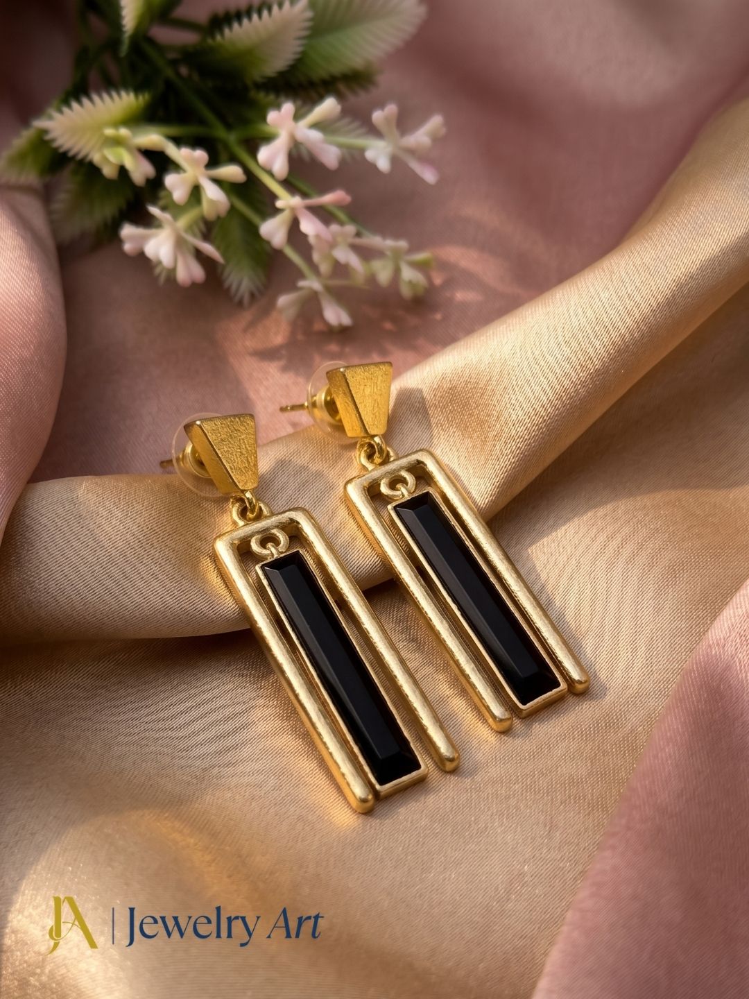 Handcrafted black onyx gemstone dangle earrings showcased in a luxury decorative jewelry photoshoot
