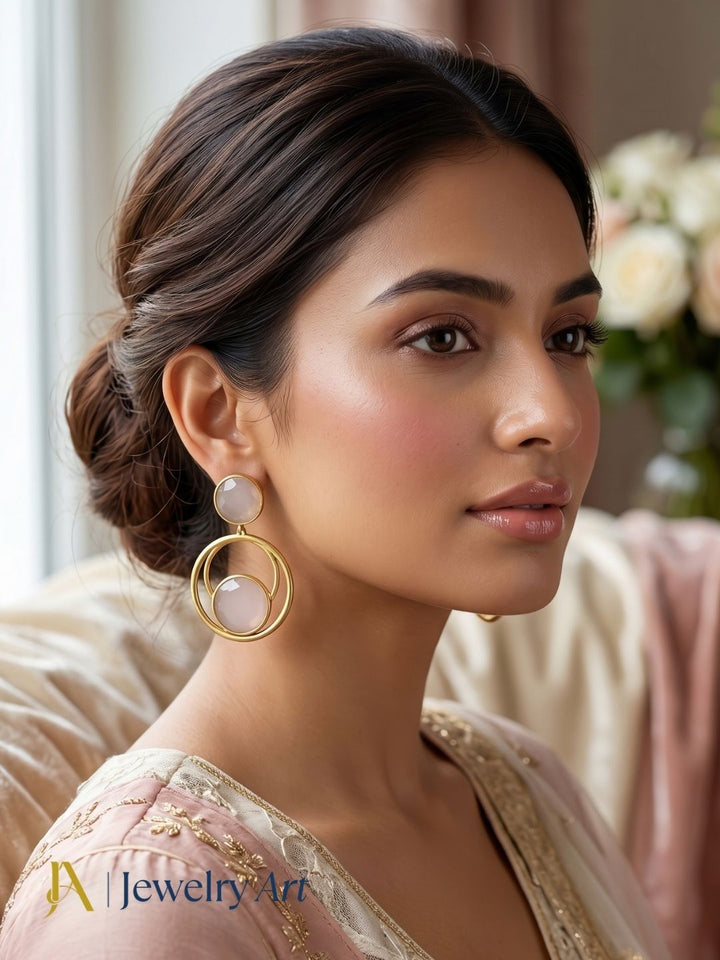 Woman wearing designer gold plated Rose Quartz semi-precious gemstone lightweight dangle earrings.
