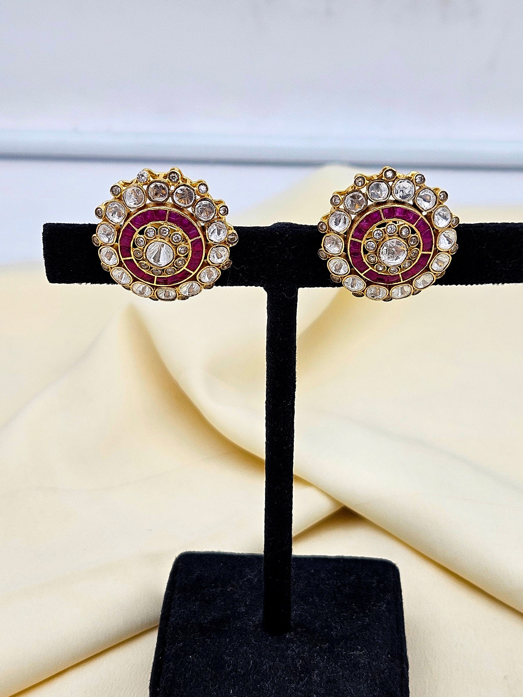 Designer AD polki red stone stud earrings showcased on earring display stand – stylish daily wear accessory
