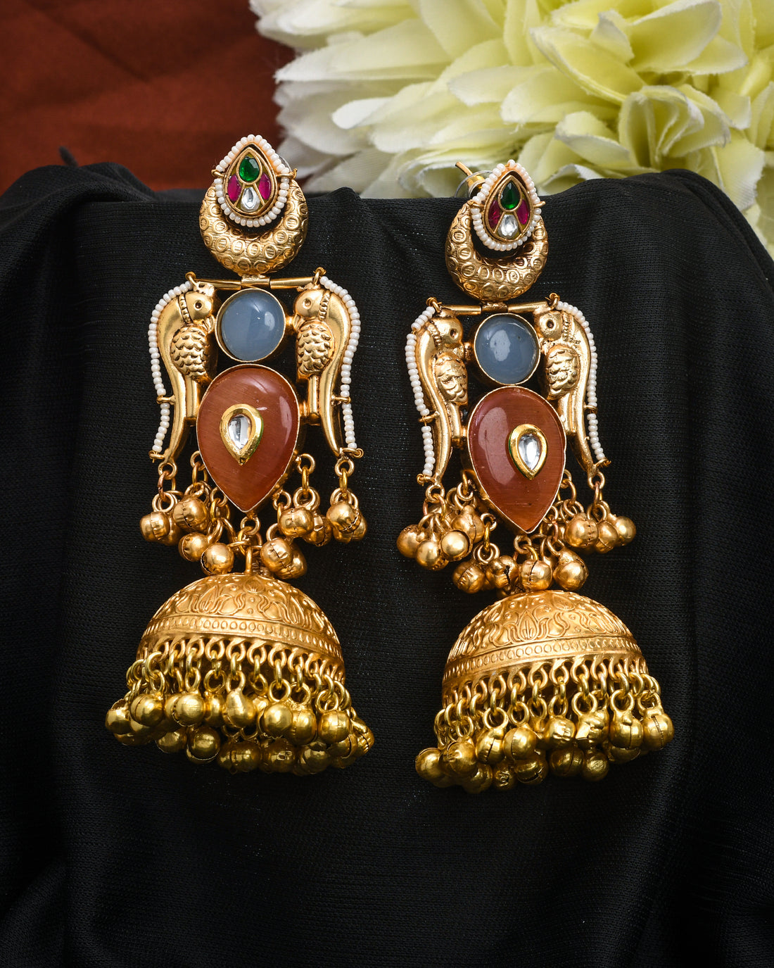 Traditional jhumka earrings in antique gold with vibrant Kundan Polki stones in multi-color and drop dangle design
