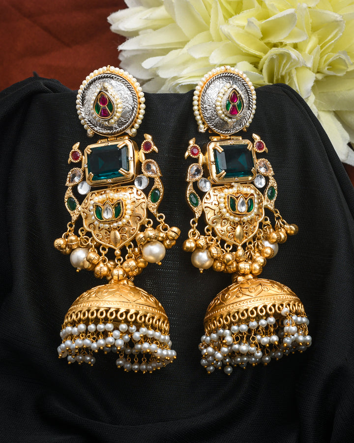 Multi-color motif jhumka earrings with antique gold finish in a classic dangle drop design
