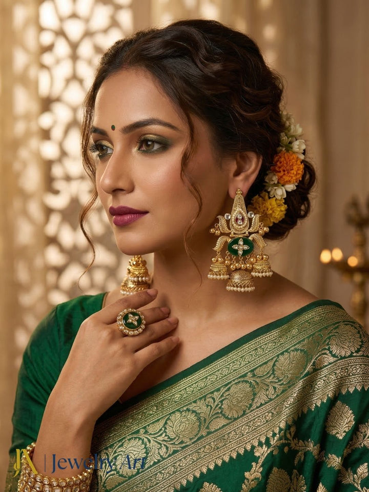 Designer long jhumka earrings with green glass , polky accents and pearl drop design
