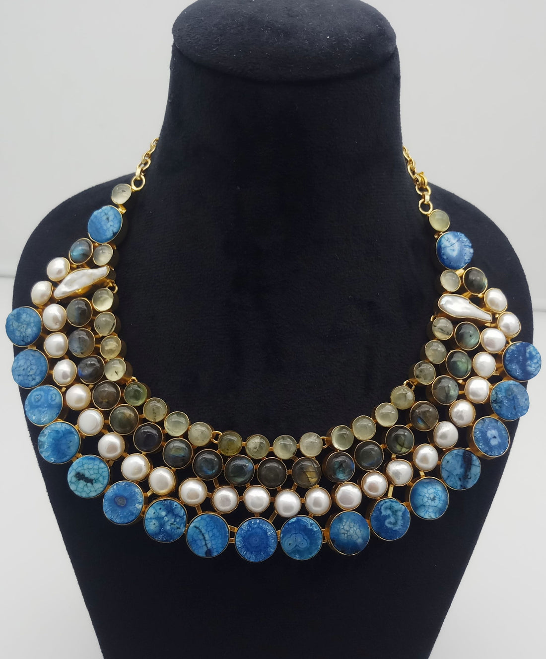 Designer necklace with mixed gemstones and antique gold plating styled on neck – includes Prehnite, Labradorite, Solar Quartz, and pearls
