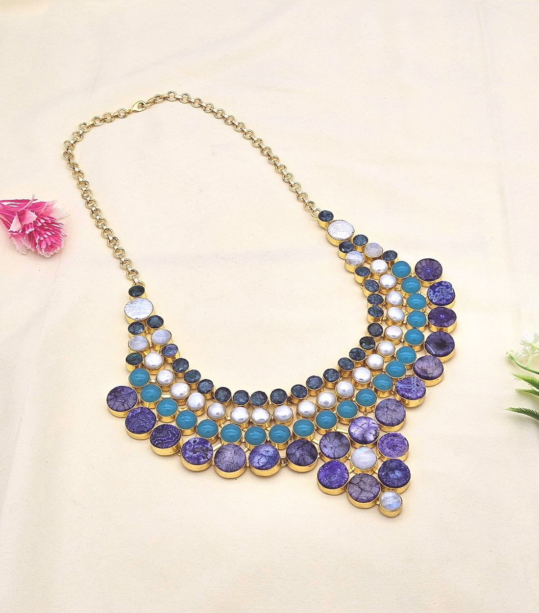 Broad statement necklace in antique gold plating featuring Hathipara, pearl chalcedony, and solar quartz stones
