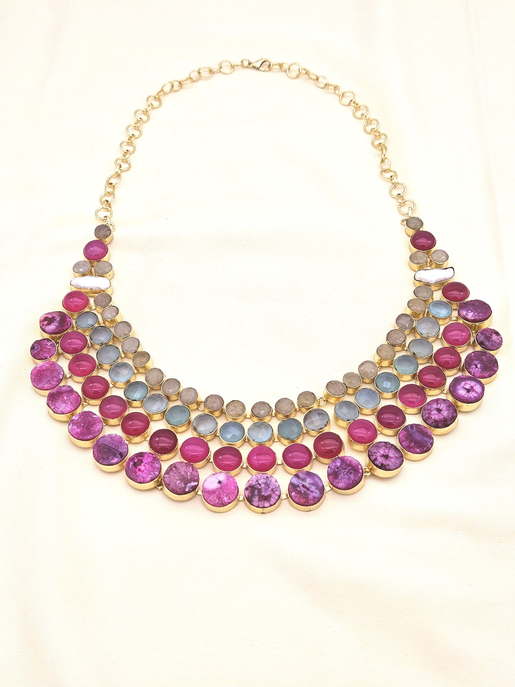 Statement necklace featuring magenta Onyx, Chalcedony, solar quartz, and pearls in antique gold finish
