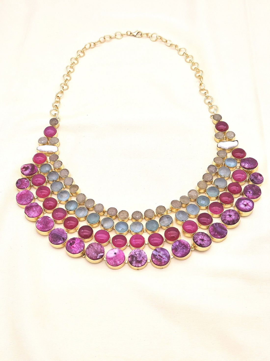 Statement necklace featuring magenta Onyx, Chalcedony, solar quartz, and pearls in antique gold finish
