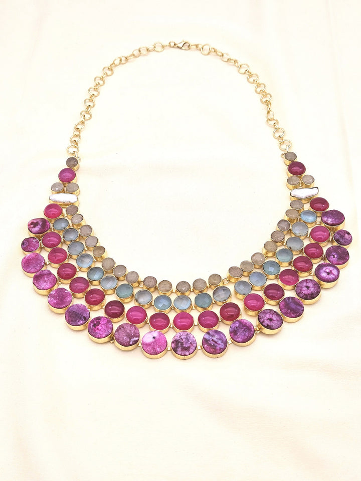 Statement necklace featuring magenta Onyx, Chalcedony, solar quartz, and pearls in antique gold finish
