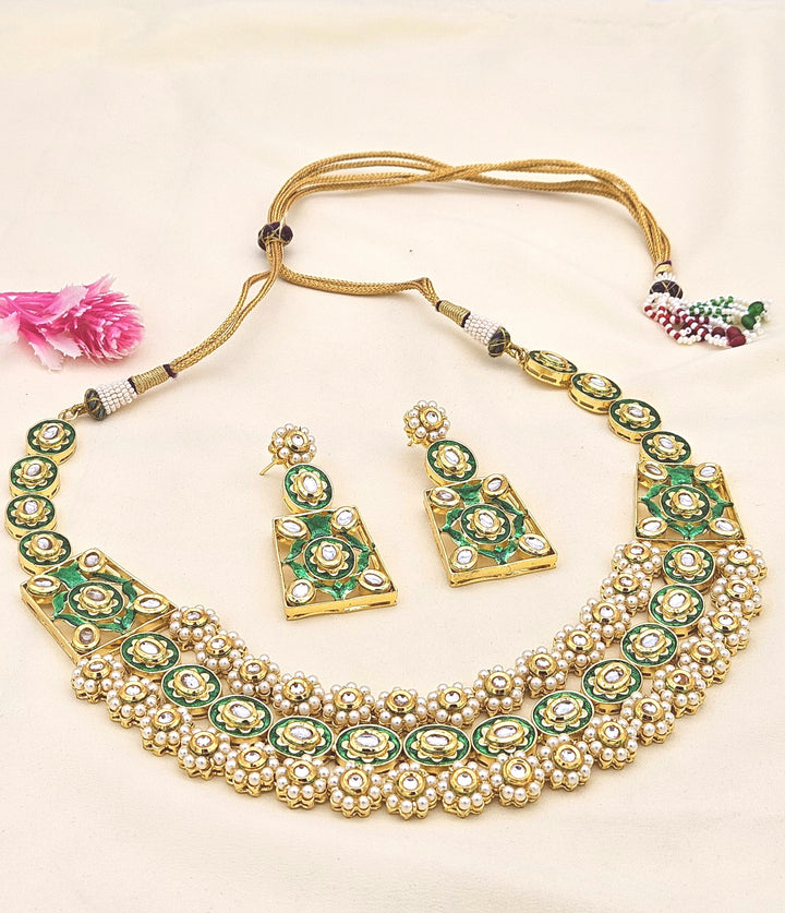 Handcrafted antique gold-plated Polki Kundan-Meena necklace and earring set adorned with lustrous pearls, inspired by royal Indian heritage
